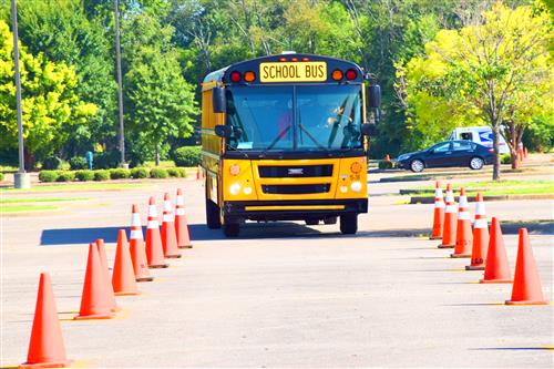 bus driving through traffic cones 